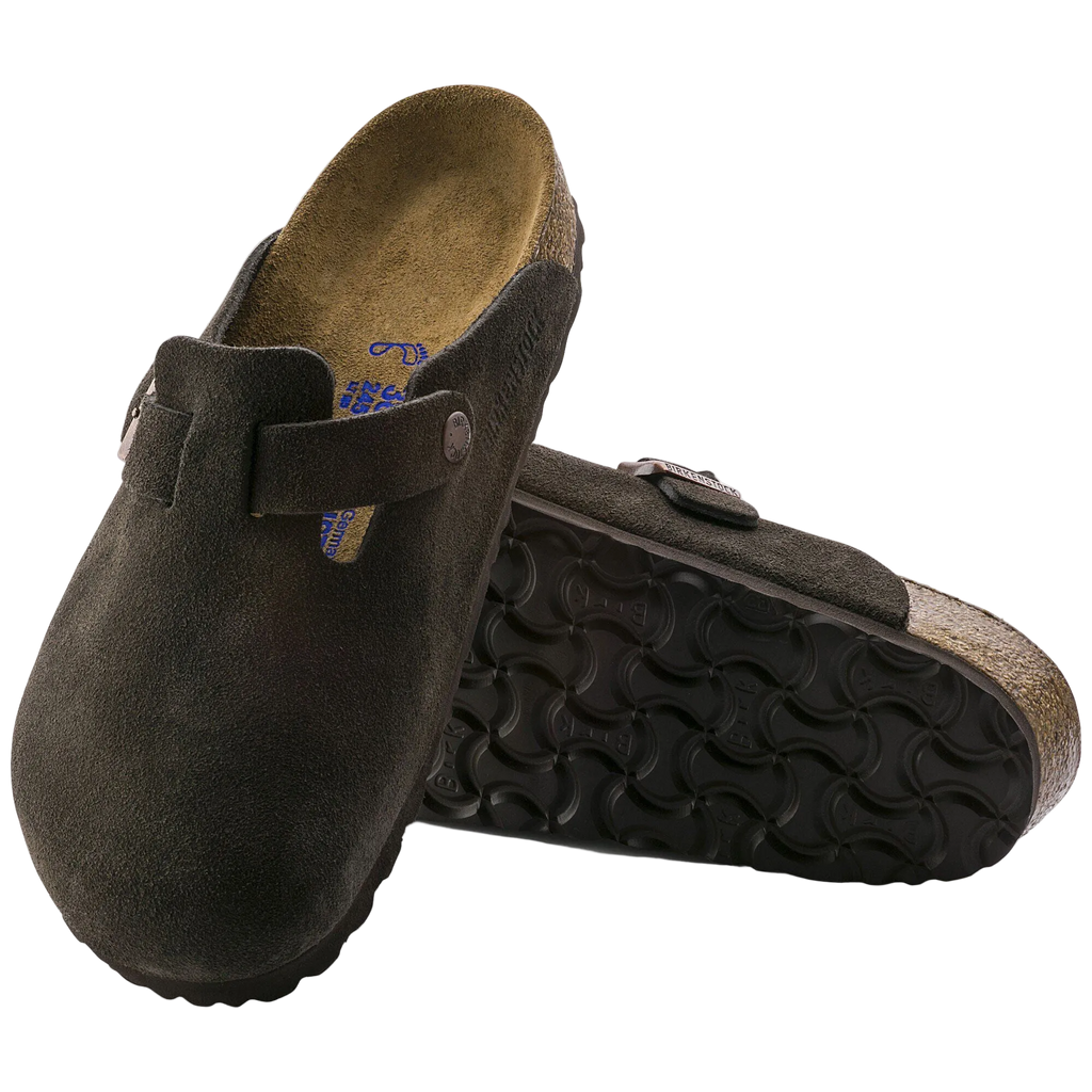 Brown suede clogs with cork sole on a white background