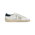 White sneaker with navy accents on a light beige background