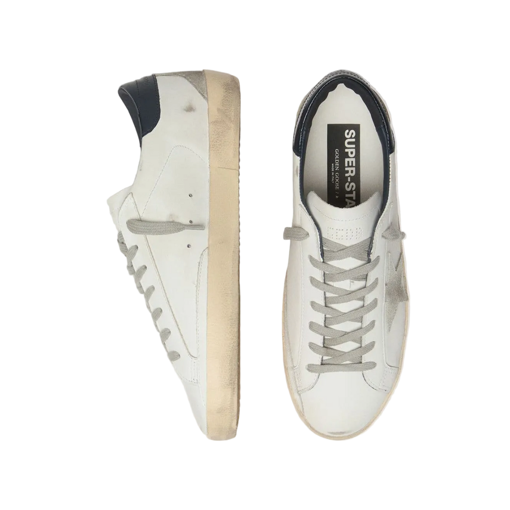 White sneakers with a visible brand logo on a light gray background