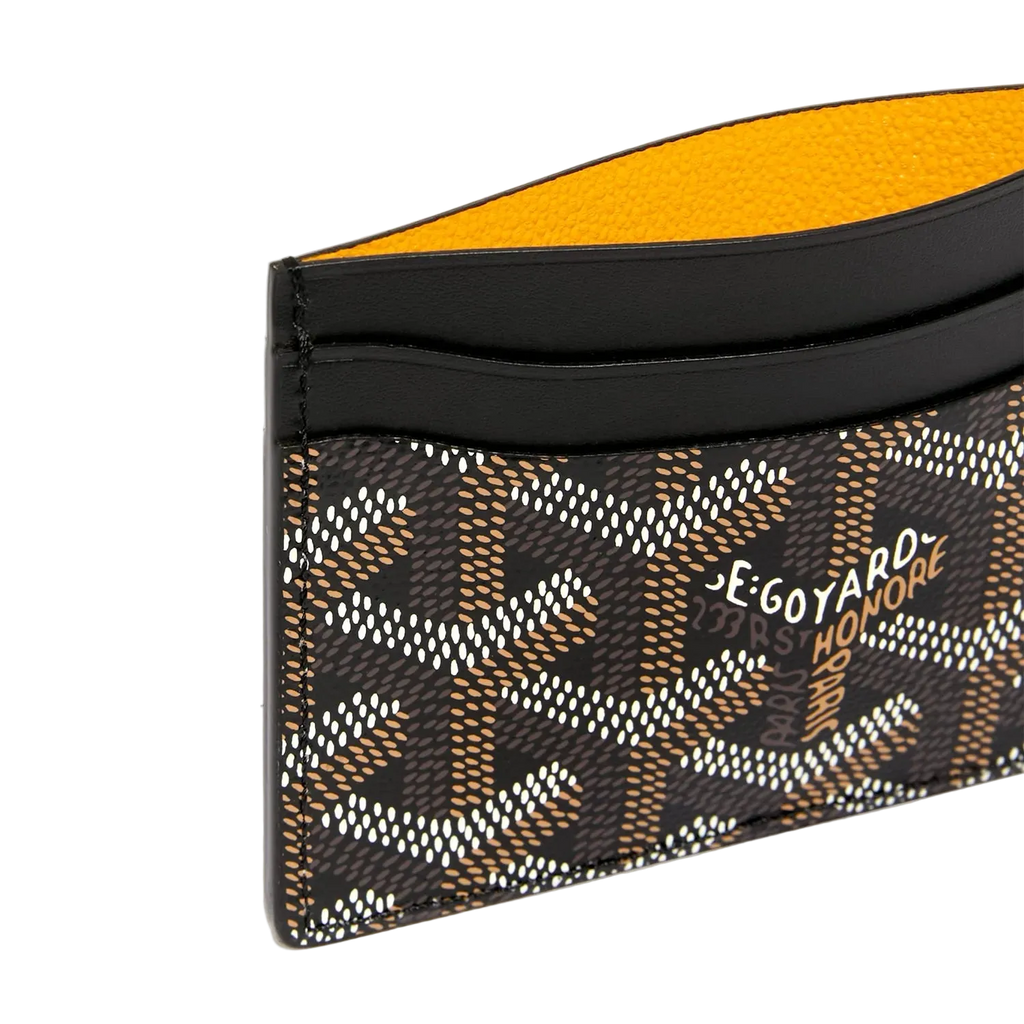 Goyard cardholder with black and yellow design on a white background