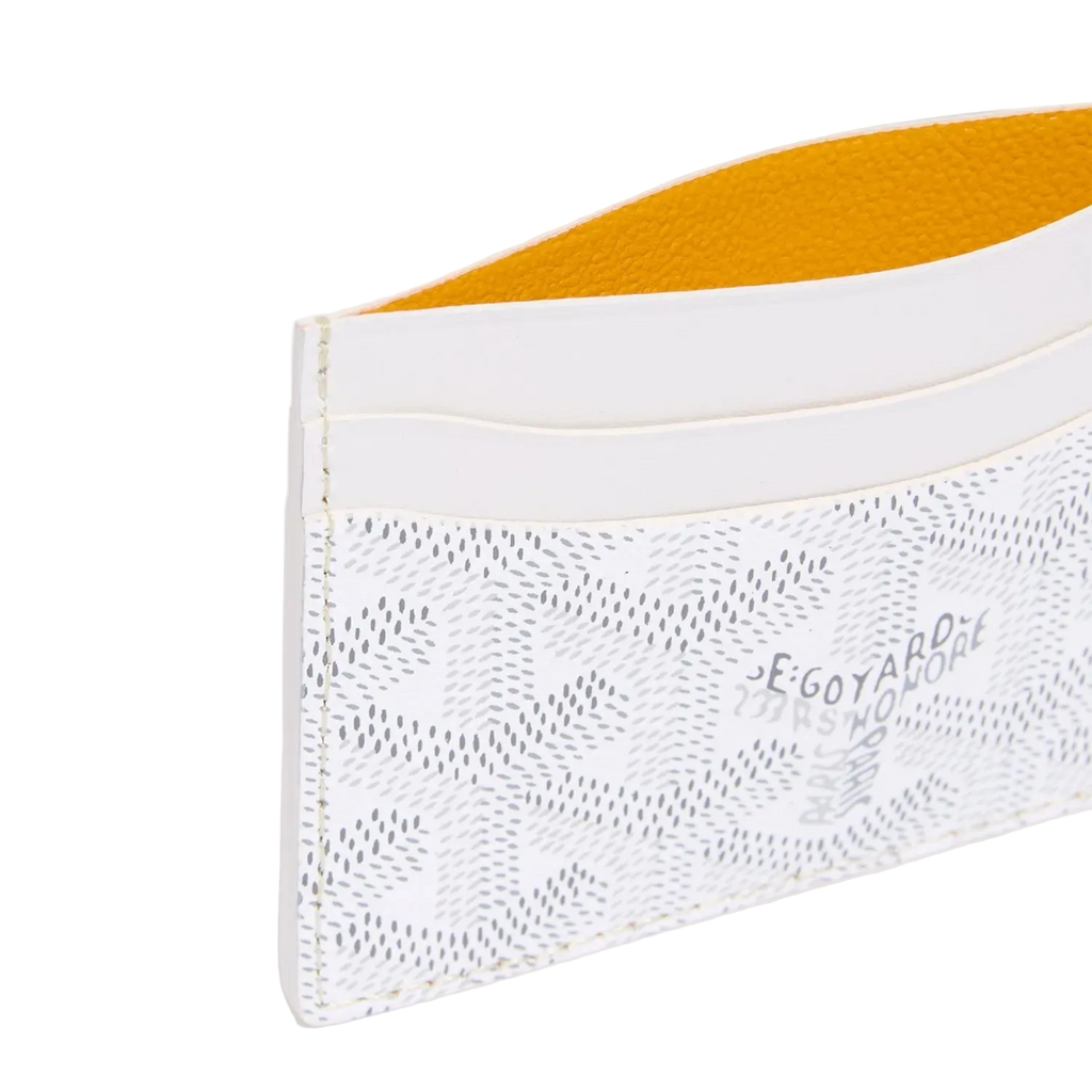 White cardholder with yellow interior on a light gray background