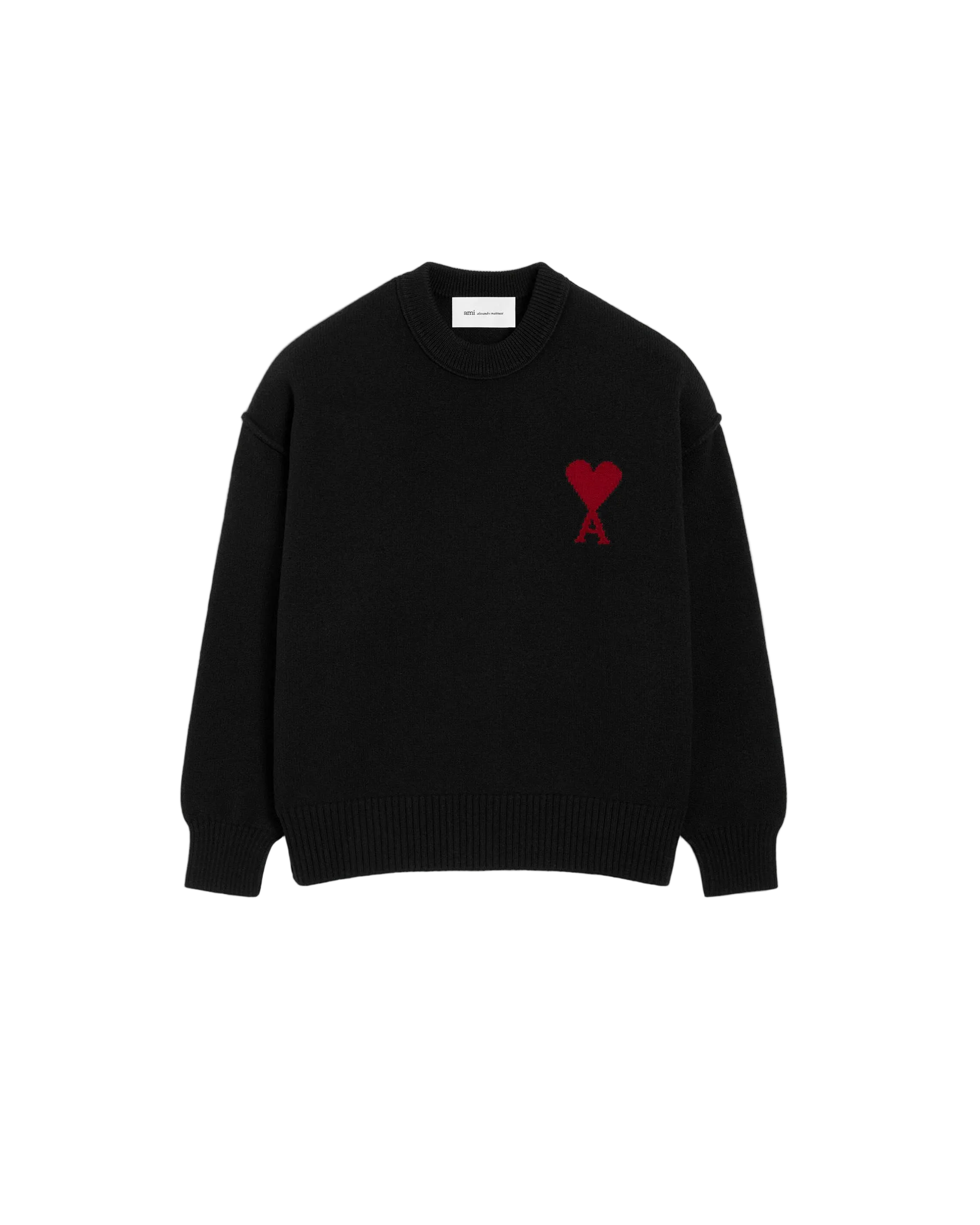 Black sweater with a red heart logo on a beige background