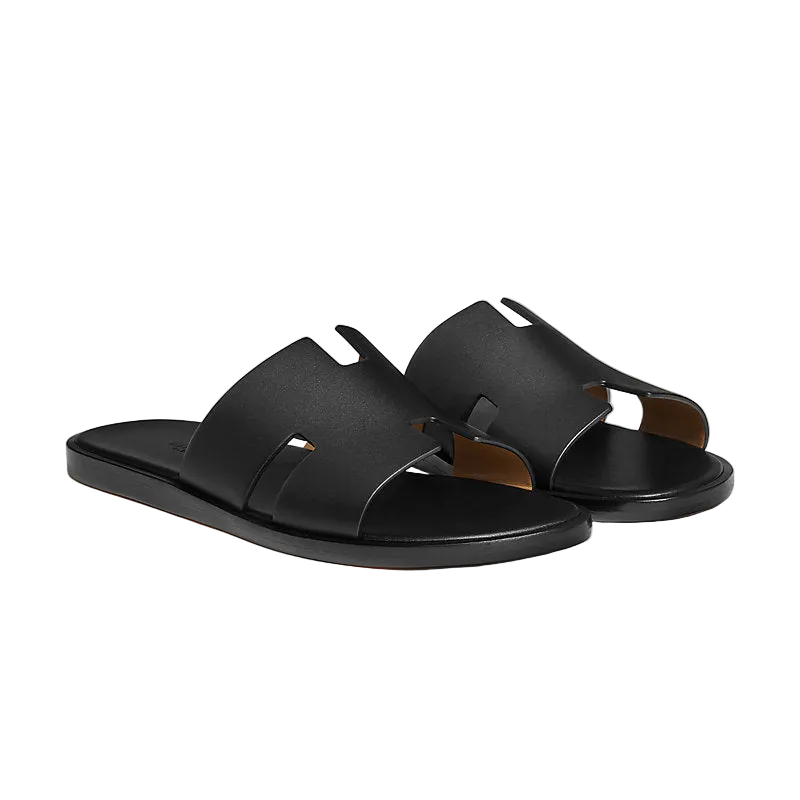 Pair of black sandals on a light gray background